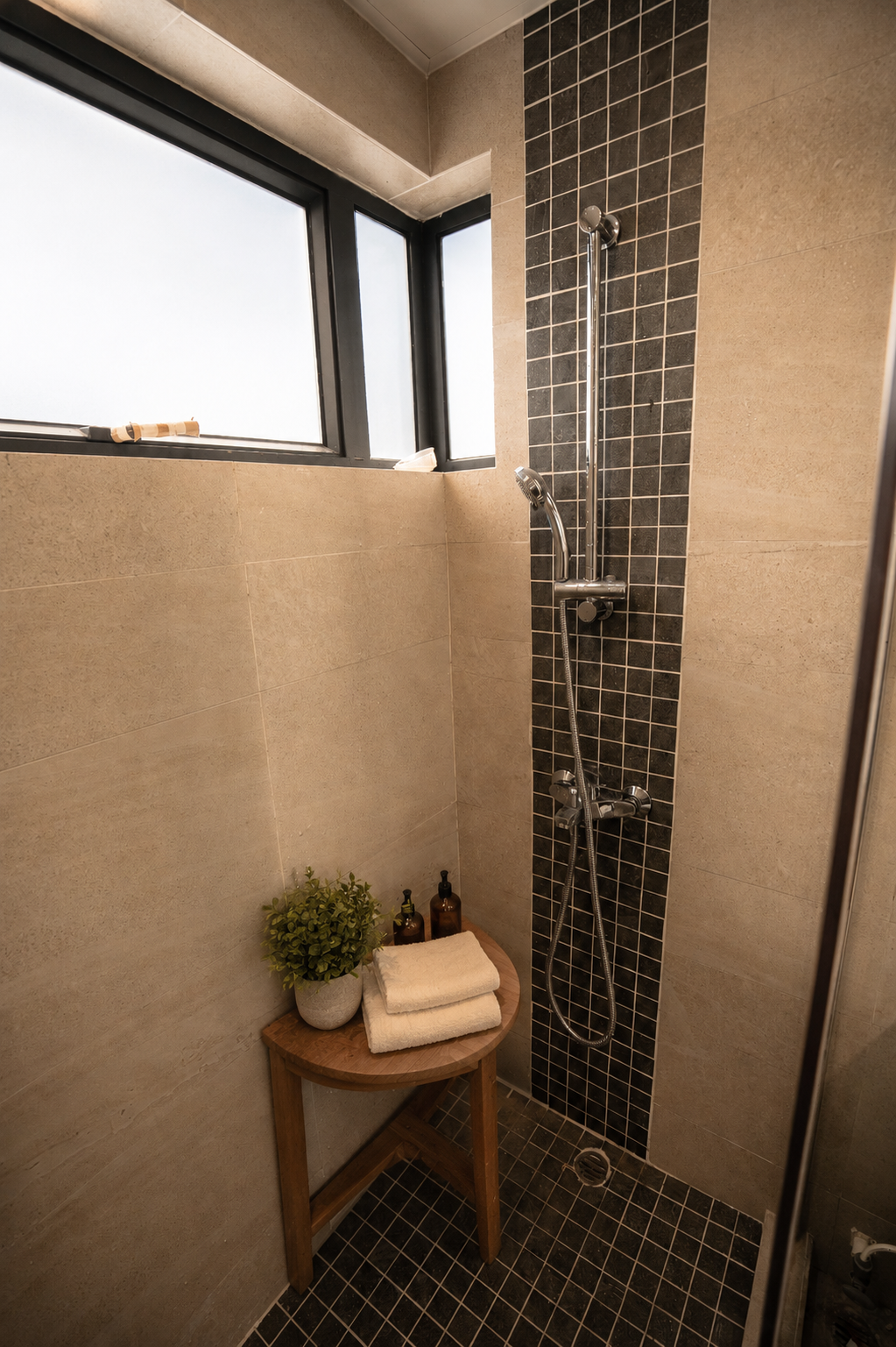 Virtually styled shower room with teak furniture, folded towels, planting and premium toiletries
