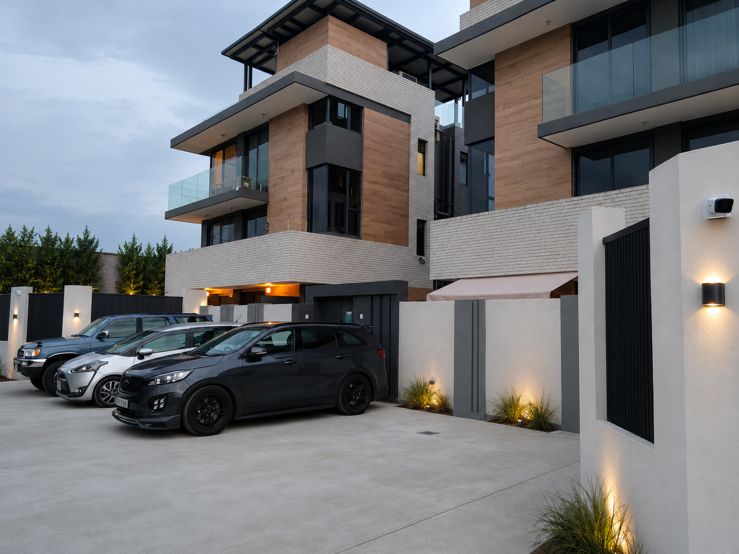 Enhanced street-level presentation showing warm timber-look cladding, architectural lighting and private entrances